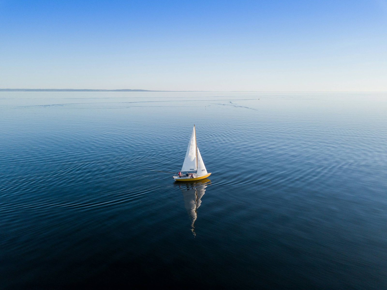 A sailboat under way on calm open water